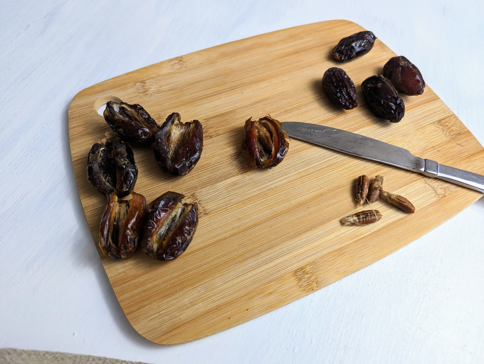 Pitted dates on a cutting board