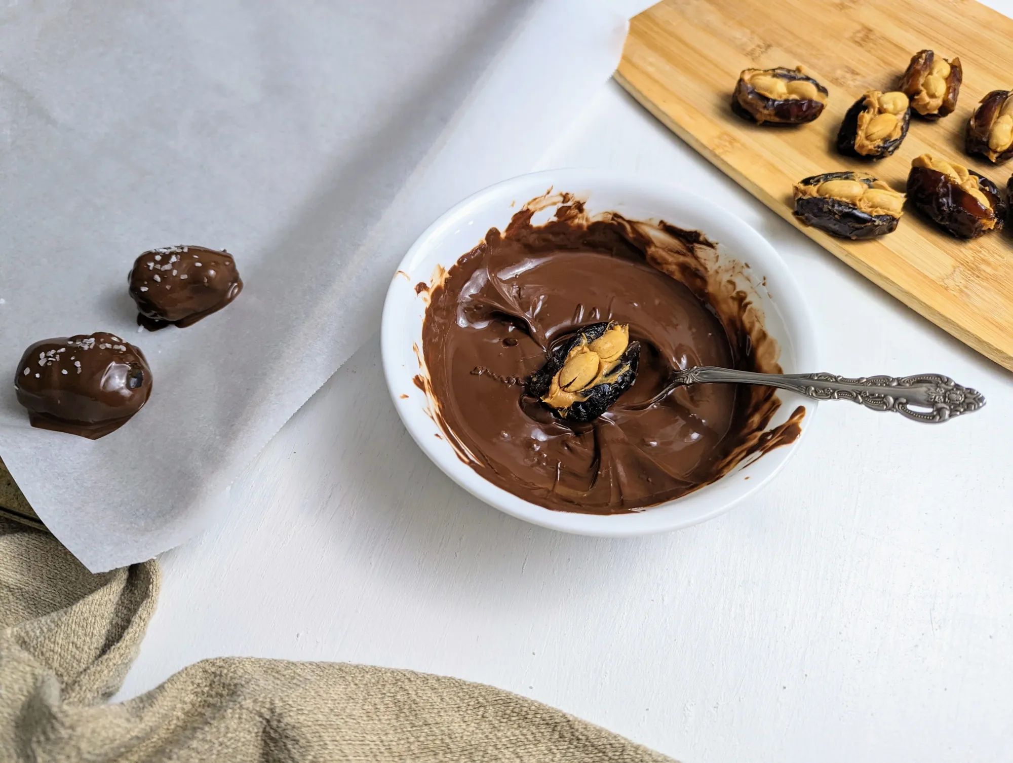 Stuffed date in a bowl of melted chocolate