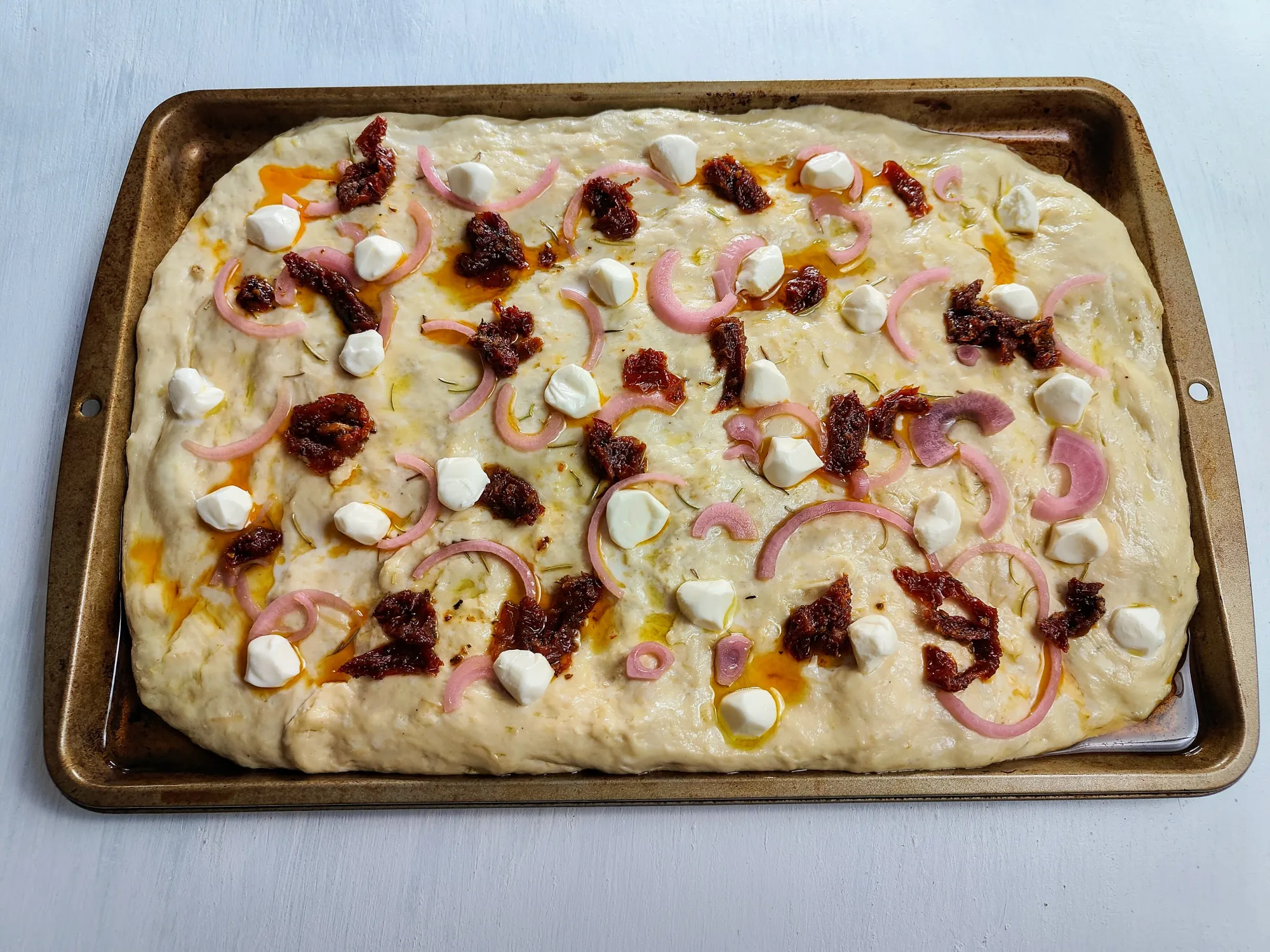 Focaccia dough on a baking sheet