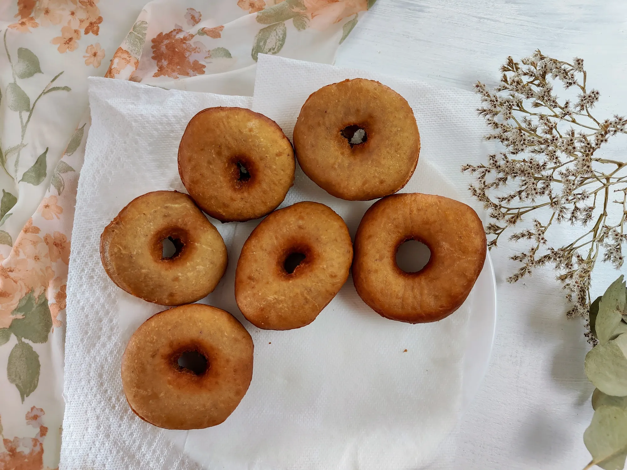 Unglazed donuts on a plate with paper towells