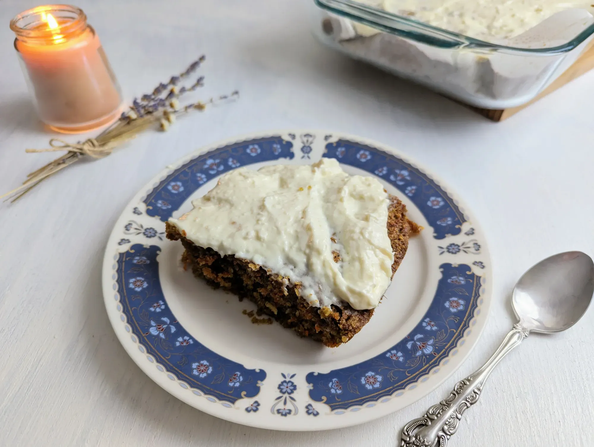 A slice of carrot cake baked oats topped with cream cheese frosting