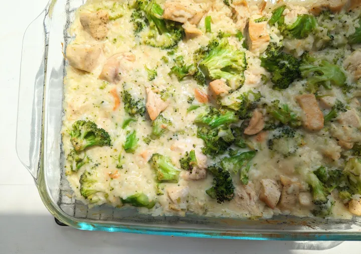 Chicken, rice, and broccoli casserole in a casserole dish on a cooling rack